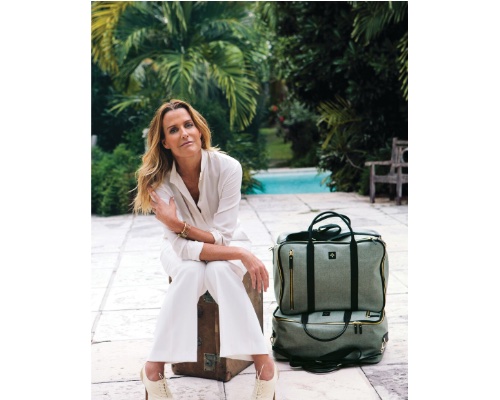 India Hicks posing poolside with luggage